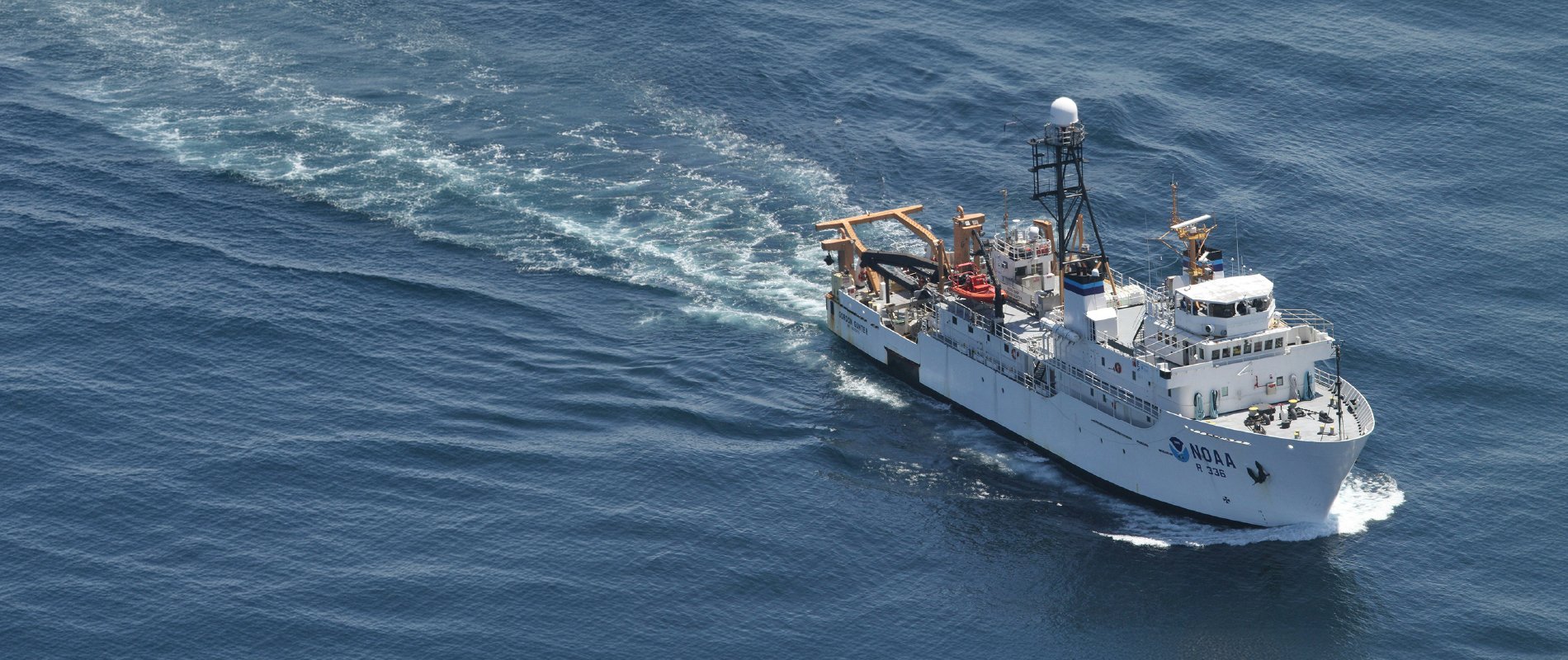 Research vessel travelling across open water